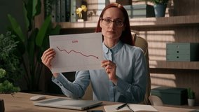 Sad frustrated businesswoman office broker trader saleswoman data analyst woman showing document report loss sales graph diagram chart business investment crypto bitcoin finance debt crisis bankruptcy - Powered by Shutterstock - Get 15% off with code: PIKWIZARD15