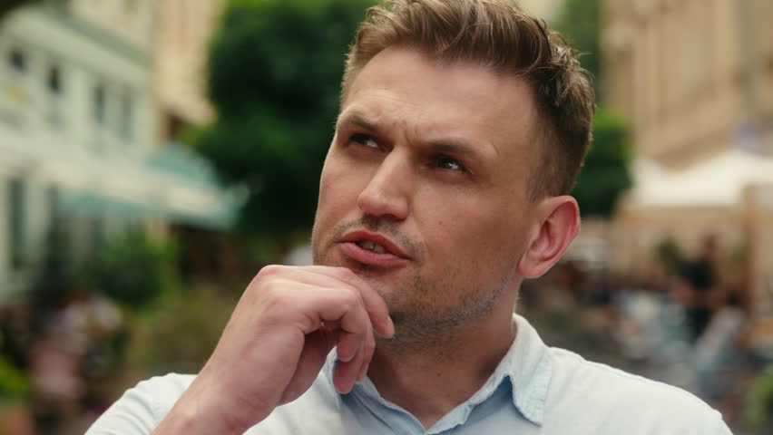 Close up thoughtful guy tourist Caucasian man businessman pensive thinking outdoors male businessman doubt think ponder consider problem solution hold hand on chin choose plan dream in city outside