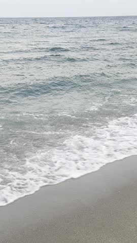 Ocean waves gently rolling onto the shore under natural daylight. The scene captures the rhythm and texture of the sea, evoking calm, nature, and open space.
