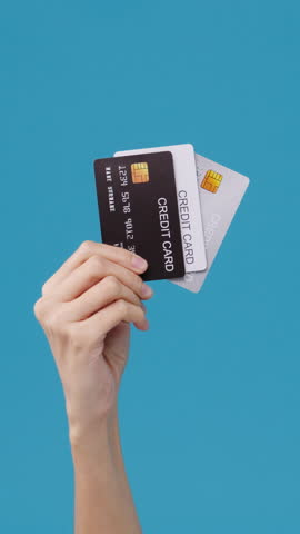 Vertical Screen : Young woman hand shows credit card for shopping online over blue background in studio. Copy space for place a text, message for advertisement. Advertising area, mockup promotional.