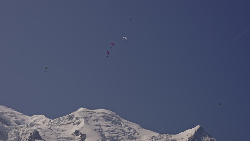 Paragliders Go Paragliding Over Mont Blanc Mountain in French Alps