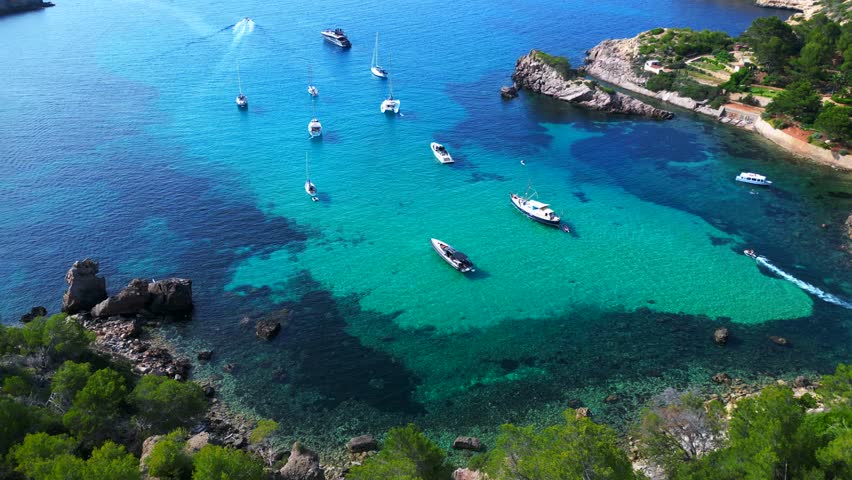 Sailboats yachts moored Ibiza blue water bay Unique aerial view flight drone