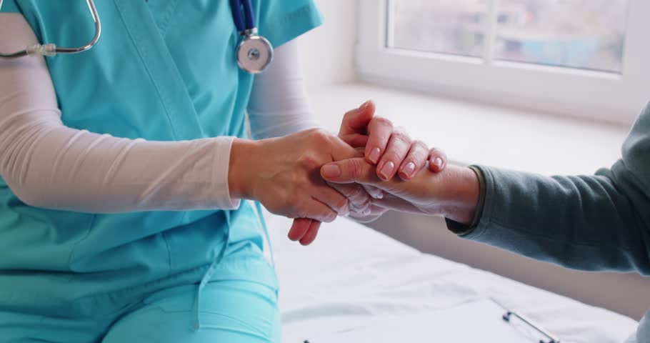 Caring nurse hand holding, geriatric kind medicine doctor in clinic, nurse, physician helping old senior, supports handicapped patient, medical rehabilitation, assistant, caregiver gives assistance