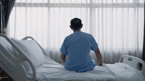 Rear view of sick old man sitting on bed looking at window inside hospital in lonely, depressed and hopeless attitude, health concept.
 - Powered by Shutterstock - Get 15% off with code: PIKWIZARD15