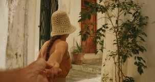 Woman leads by hand through a cozy courtyard in a historic town Atrani in Italy - Powered by Shutterstock - Get 15% off with code: PIKWIZARD15