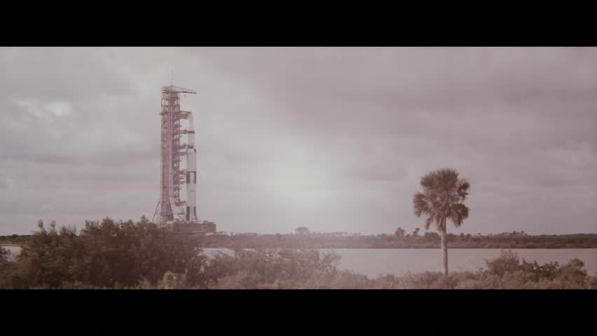 FLORIDA - 1969 - Long shot across the water of the Apollo 12 spacecraft being transported to its launch pad at the Kennedy Space Center.