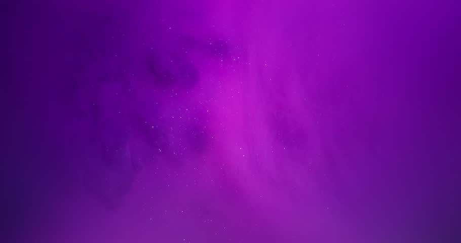 Flowing ink. Fluid splash. Defocused purple blue neon color sparkling swirling glitter wet texture floating on abstract pink background.