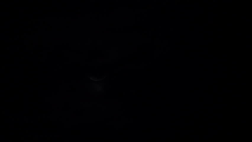 Thin clouds are drifting across the crescent moon in the night sky in Fukuoka city Fukuoka prefecture, Japan. without sounds