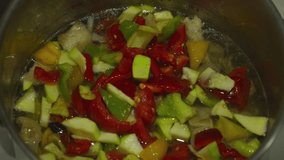 Hand placing colorful bell peppers into a pot with other vegetables. Slow motion scene highlighting red, yellow, and green peppers. Ideal for food, recipe, or kitchen visuals. - Powered by Shutterstock - Get 15% off with code: PIKWIZARD15
