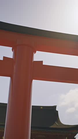 Explore Fushimi Inari in Kyoto, Japan with vibrant torii gates under sunny skies