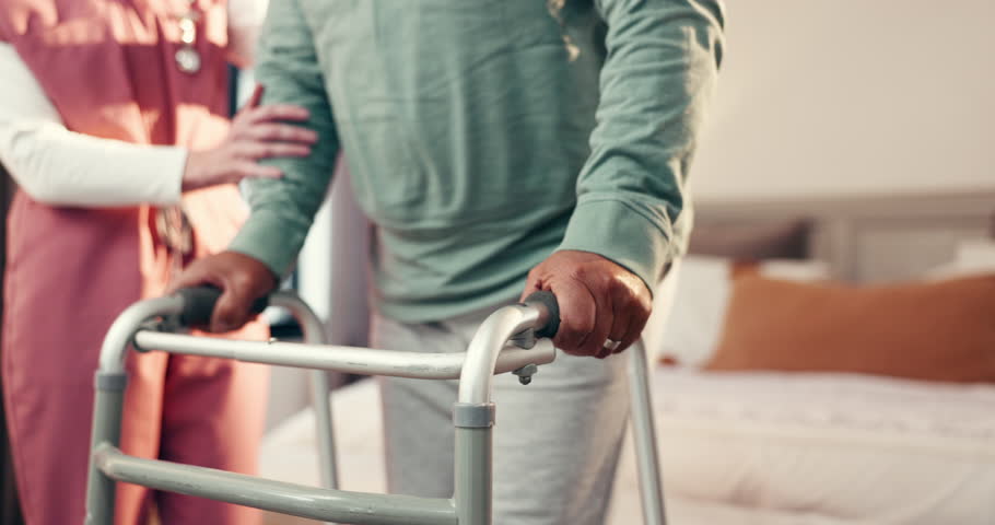 Nurse, hands and senior with walker for assisted living or help in bedroom or retirement home. Man, caregiver and aiding elderly person with a disability or patient for mobility, balance or recovery