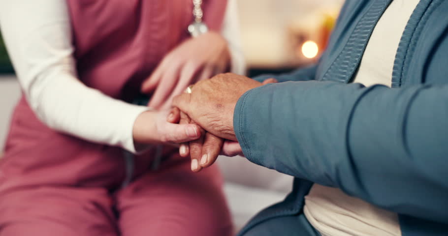 Nurse, hands and senior patient with empathy for understanding, healing or rehabilitation in home. People, caregiver or elderly care with sympathy for comfort, support or trust in retirement house