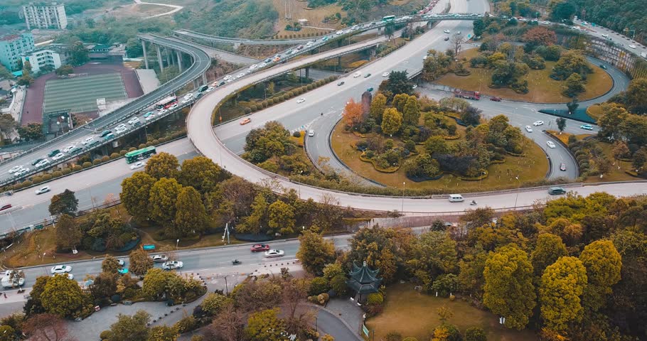 Discover the Sassie Interchange from above, showcasing the intricate road network and vibrant surroundings. Experience the harmonious blend of asphalt and nature in this urban area.