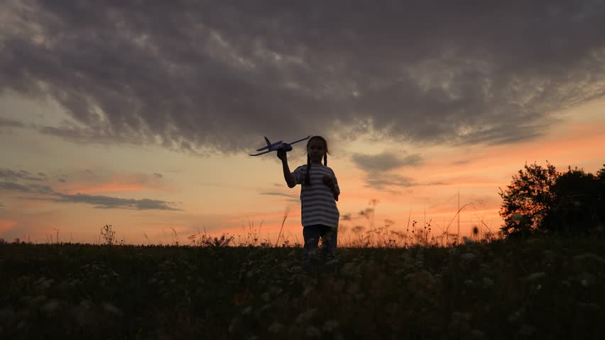 baby girl playing airplane pilot, kid dream flying, kid superhero, Child with toy airplane at sunset, Dreaming of flying, Kid playing outdoors in evening, Silhouette of a boy with plane, Imagining