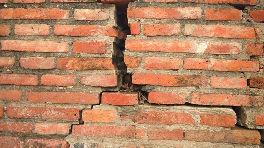 Cracked antique red brick wall with aged lines and crumbling surface from temple ruins