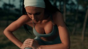 A strong young woman takes a breather after training outdoors. Leaning forward with focus, she shows determination, effort, and a fit, disciplined lifestyle. - Powered by Shutterstock - Get 15% off with code: PIKWIZARD15