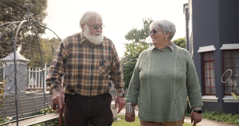 Talk, walk and old couple in yard with love, relationship and bonding at nursing home together. Outdoor, pensioner and elderly people in retirement to relax with care, support or conversation on date