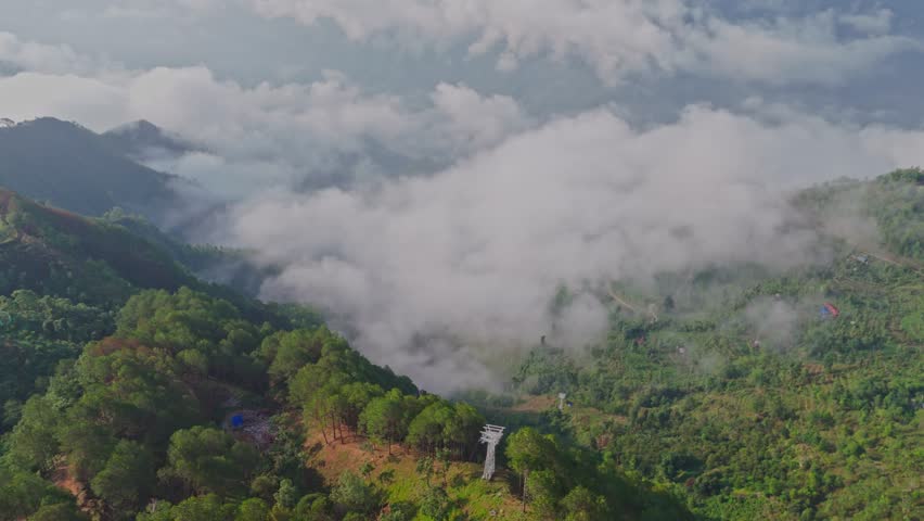 This aerial video shows Manakamana Hill in Gorkha, Nepal, a spiritual and scenic site known for its Hindu temple, panoramic mountain views, and the cable car that connects pilgrims to the hilltop.