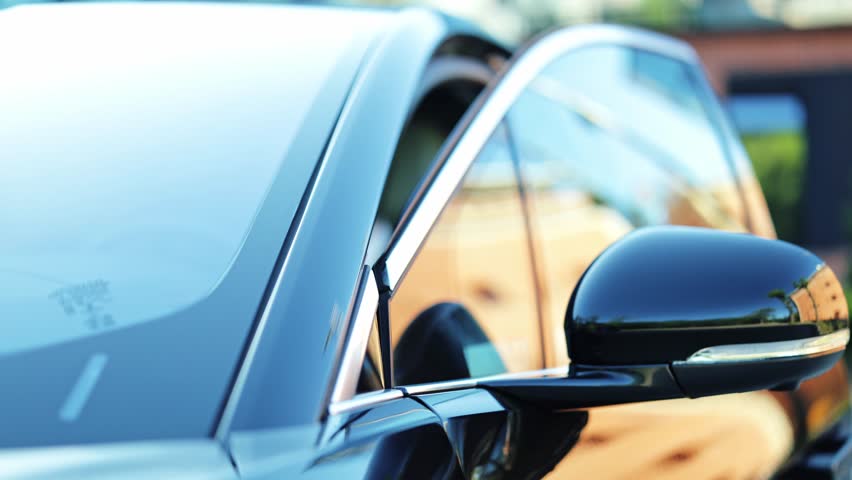 Professional businessman in a dark suit talks on his smartphone outdoors, near a luxury car. Focused and busy, the man calmly enters the vehicle. - Powered by Shutterstock - Get 15% off with code: PIKWIZARD15