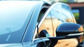 Professional businessman in a dark suit talks on his smartphone outdoors, near a luxury car. Focused and busy, the man calmly enters the vehicle. - Powered by Shutterstock - Get 15% off with code: PIKWIZARD15