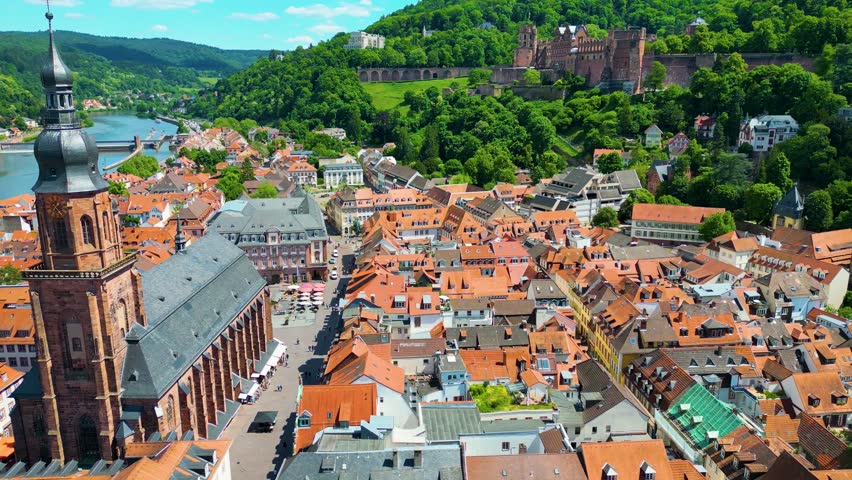 4K Aerial Drone Video of Historic Heiliggeistkirche Church and Castle on Königstuhl Hill overlooking the Neckar River in Heidelberg, Germany