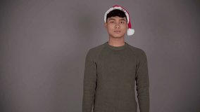 Portrait of Happy Young Asian Man with Megaphone Wearing Santa Hat, Christmas Holiday Concept - Powered by Shutterstock - Get 15% off with code: PIKWIZARD15