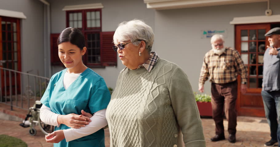 Nurse, old woman and holding hands on walk, outdoor or listen with comfort, support and story. People, elderly person and volunteer caregiver at retirement village, clinic or discussion with services