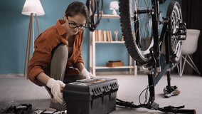 female cyclist repairing bicycle using tools toolbox for maintenance. woman with bike on repair-stand. - Powered by Shutterstock - Get 15% off with code: PIKWIZARD15