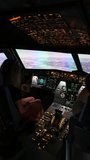 Vertical view of Airbus A320 cockpit during flight, from pilot’s perspective with glowing instrument panels. - Powered by Shutterstock - Get 15% off with code: PIKWIZARD15