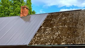Dirty and clean contrast of corrugated roof showing moss buildup and renovation - Powered by Shutterstock - Get 15% off with code: PIKWIZARD15