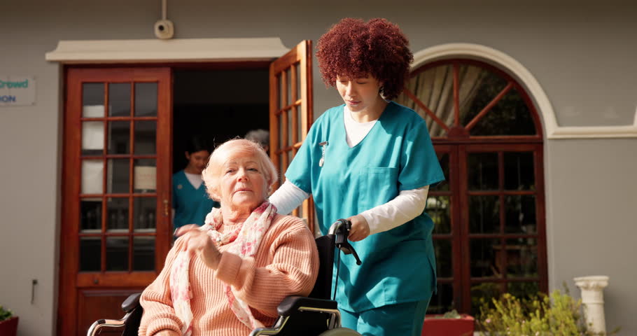 Woman, nurse and wheelchair with senior patient in retirement home for assisted living or help. Female people, caregiver and walking elderly person with a disability for healthcare at old age center