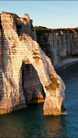 Stunning sunset over the cliffs of Etretat in Normandy capturing natural beauty and tranquility