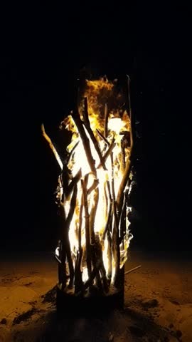 Slow-motion fire, meditative flames, cinematic heat. Close-up of a bonfire captured in slow motion, with glowing embers and dancing flames, evoking warmth, mystery, and primal connection.