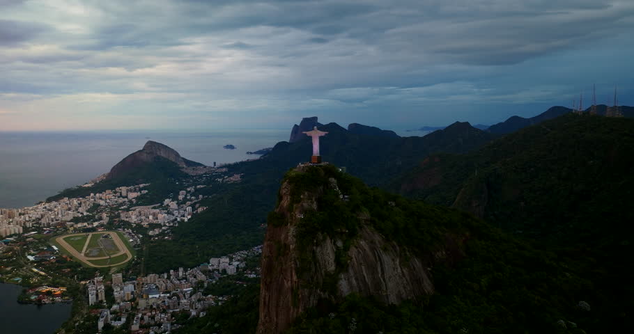 Christ the Redeemer at dawn, iconic monument on Corcovado Mountain overlooks Rodrigo de Freitas Lagoon and the city, Rio de Janeiro, Brazil. Aerial drone panoramic view