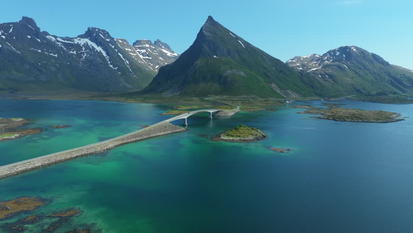 Scenic aerial footage showcasing the stunning Flakstad bridges and surrounding landscapes in Lofoten, Norway, with turquoise waters and majestic mountains
