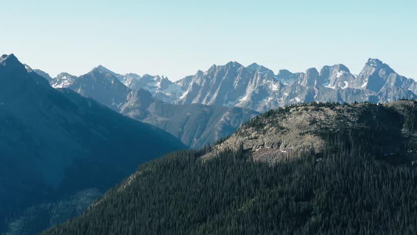 Tracking aerial shot of the snow capped mountains of the San Juan mountain range in Colorado.