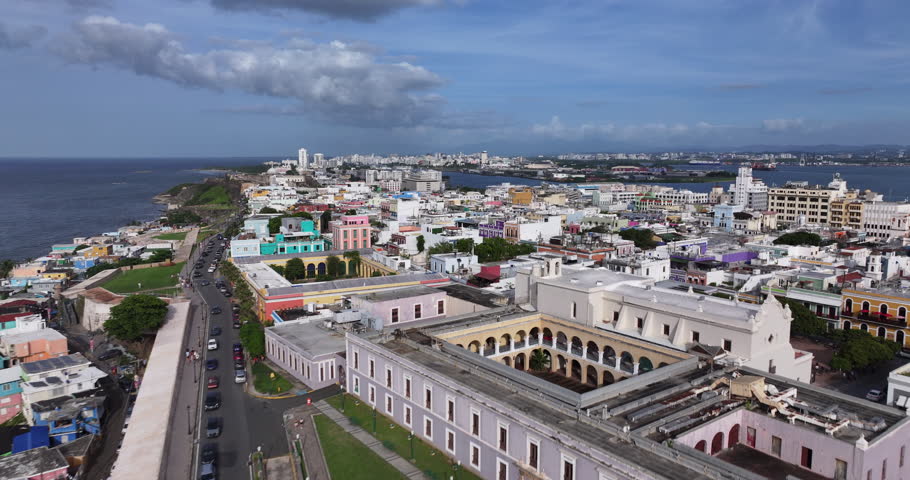 A cinematic shot of a colorful colonial street in Old San Juan, Puerto Rico, featuring historic buildings and warm natural light.