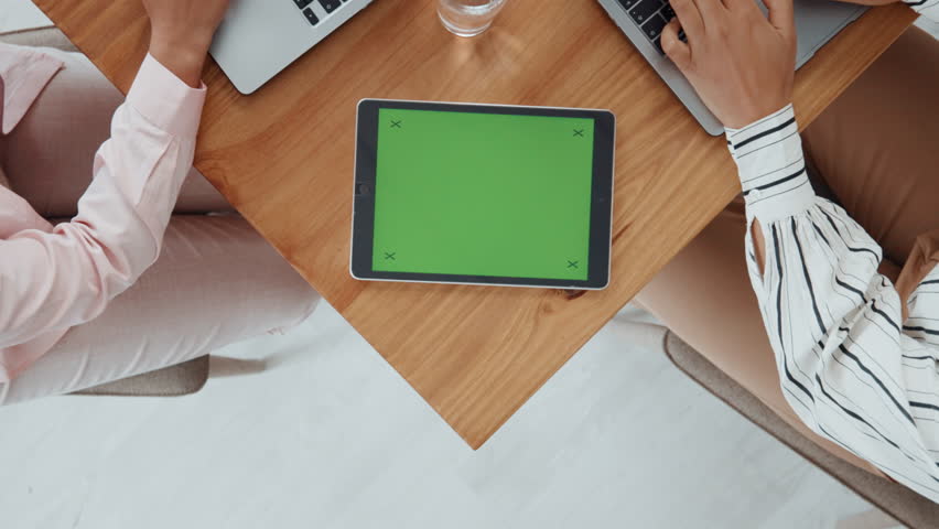 Above, green screen and business people in meeting, tablet or copywriting with website layout. Mockup space, employees or journalist in workplace, tech or app with collaboration or magazine editor