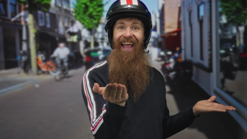 Man wearing helmet gestures with open hands on busy street under bright sunlight; joy enthusiasm optimism.