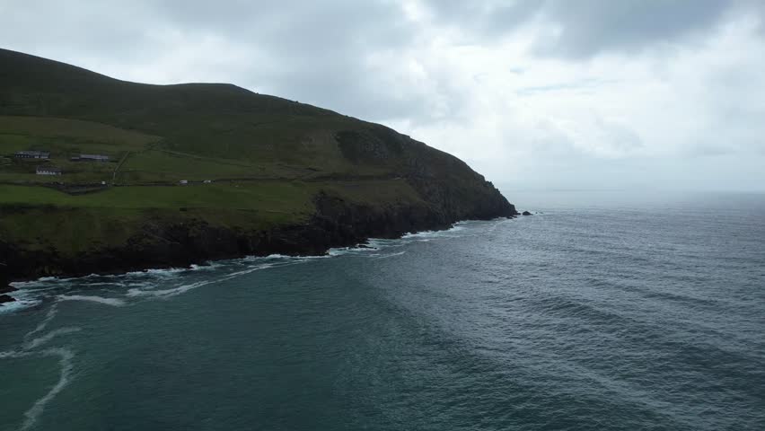 Early morning drone panning shot of Slea head to the Blasket Islands moody clouds in spectacular location Ireland Wild Atlantic Way