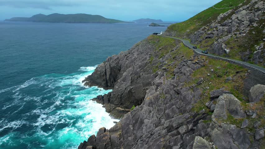 Dramatic Atlantic seas blanket Islands and winding Slea Head Above sea cliffs dramatic Kerry Ireland early morning on The Wild Atlantic Way