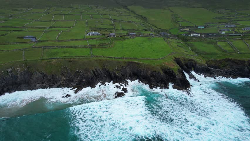 Dramatic seas Slea Head Drive cars on the Wild Atlantic way early on a summer morning Ireland Epic Locations