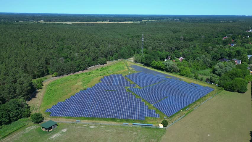 Photovoltaic panels installed on a former landfill, transforming a waste site into a source of renewable energy, a sustainable solution for the future. Nice aerial view flight descending drone