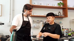 Two baristas discussing coffee preparation techniques in a modern cafe. Professional teamwork and skill-sharing in a casual setting highlight training, collaboration, and artisan beverage service. - Powered by Shutterstock - Get 15% off with code: PIKWIZARD15