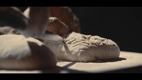 Baker Scoring Sourdough Bread Before Baking. Close-up of a hand using a lame to cut raw dough in slow motion. Artisanal bakery and traditional homemade food concept.
 - Powered by Shutterstock - Get 15% off with code: PIKWIZARD15