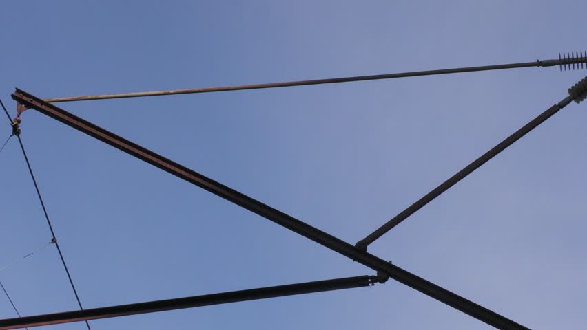 Concrete power line pole with insulators and wires — part of an overhead electricity system, commonly installed along railways to supply infrastructure and support railway electrification.