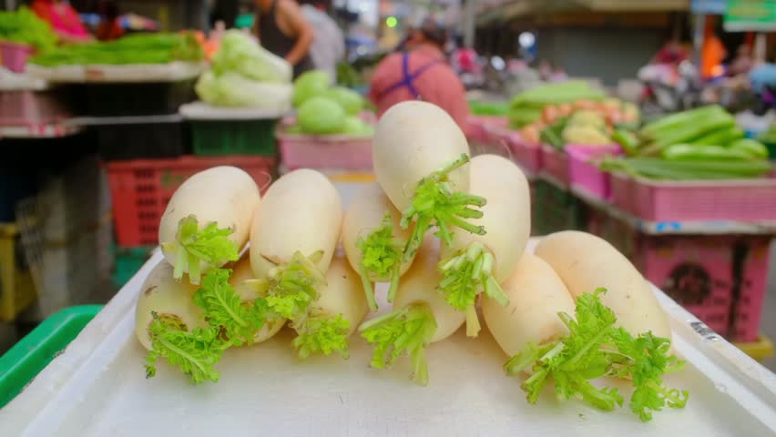 Radishes on a vegetable stall at a morning market in Thailand.