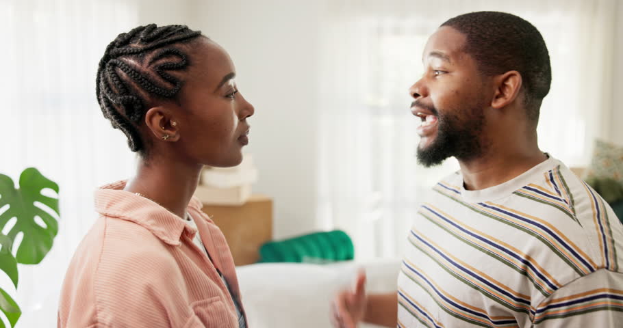 Frustrated, black couple and fight with boxes for disagreement, divorce or mistake in new home. Angry, man and woman shouting with packages or cargo for argument, break up or conflict in apartment
