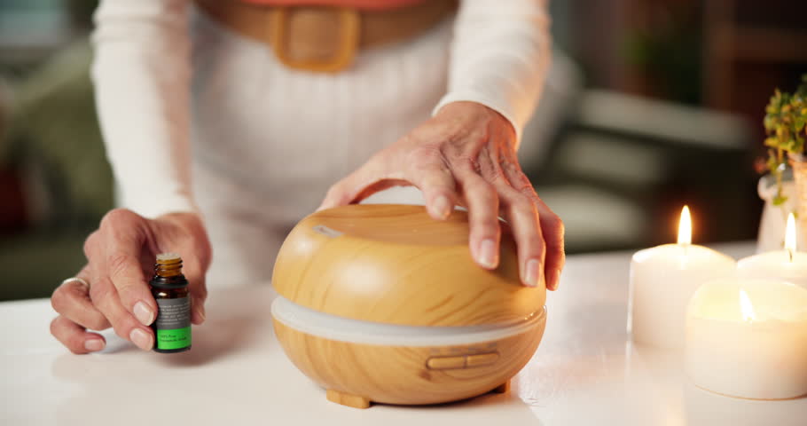 Atmosphere, hands and humidifier with person in home for aromatherapy, relax or wellness session. Ambience, essential oil and fragrance with woman getting ready for holistic healing or treatment