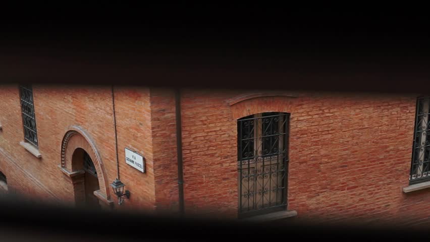 Architecture and streets of the old ancient city of Bologna. Culture and atmosphere of the Italian city center. Temples and cathedrals with red brick roofs